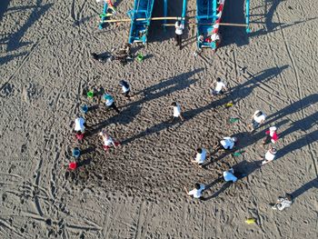 High angle view of people on sand at beach