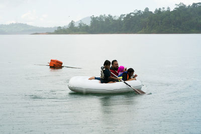 People in boat on lake