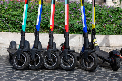 Street parking in a row of some electric scooters of various rental companies.