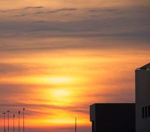 Low angle view of silhouette buildings against sky during sunset