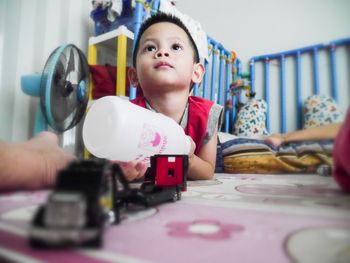 Portrait of boy looking at camera at home