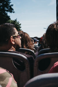 Portrait of a young couple sitting on car