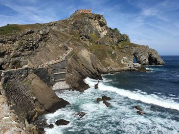 Scenic view of rocks in sea against sky