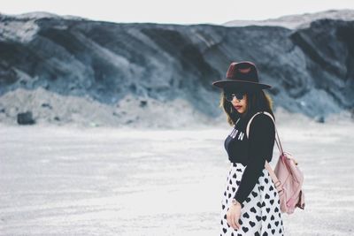 Woman standing on snow covered land