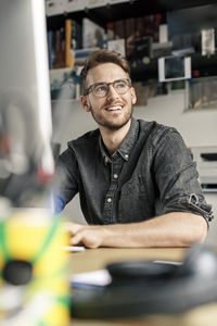 Portrait of smiling man working at desk at home