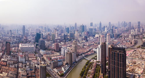 High angle view of modern buildings in city against sky