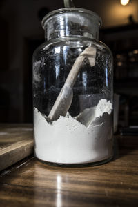 Close-up of glass of jar on table