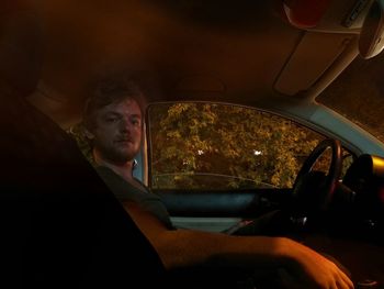 Portrait of man sitting in car