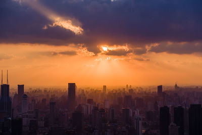 Aerial view of buildings against sky during sunset