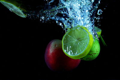 Close-up of apple against black background