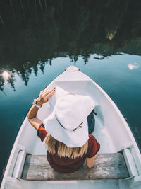 Woman in swimming pool by lake