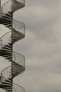 Low angle view of spiral stairs against sky