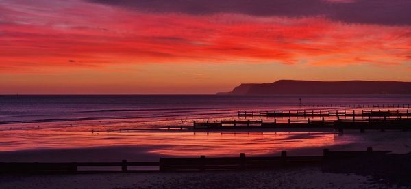 Scenic view of sea against sky during sunrise