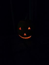 Close-up of illuminated lantern against black background