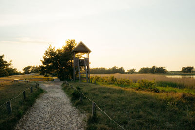 Built structure on field against sky during sunset