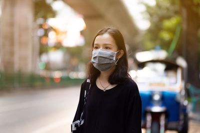 Portrait of young woman standing outdoors