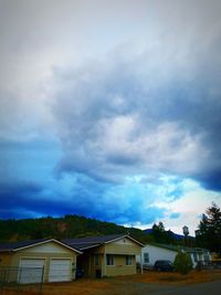 Houses against cloudy sky