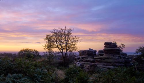 Stack of rocks against sky during sunset