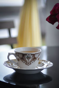 Close-up of coffee cup on table