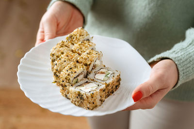 Cropped hand of person holding food