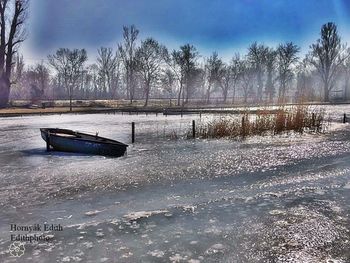 Scenic view of frozen lake against sky during sunset