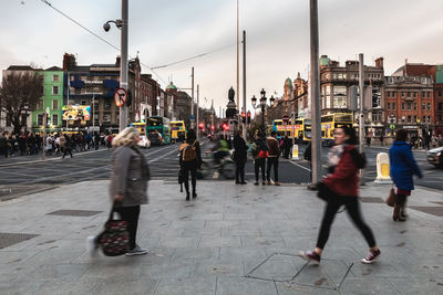 Dublin, ireland february 11, 2019 people walking down a shopping street with typical irish 