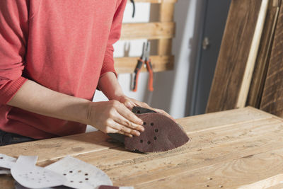 Midsection of woman working on table