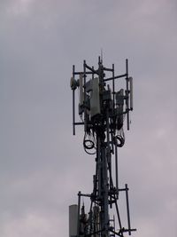 Low angle view of telephone pole against sky