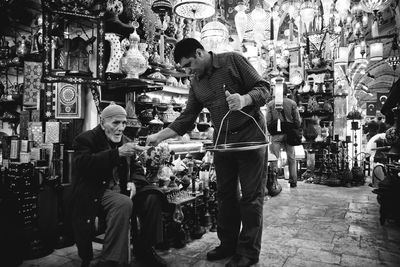 People at market stall in city