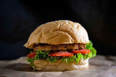 Close-up of burger against black background