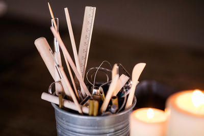 Close-up of burning candles on table