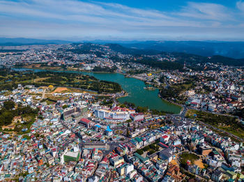 Aerial view of modern buildings in city against sky