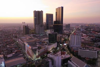 High angle view of buildings against sky during sunset