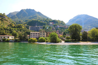 Scenic view of lake and buildings against sky