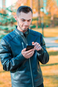 Mid adult man using mobile phone