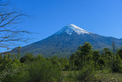 Scenic view of mountains against clear blue sky