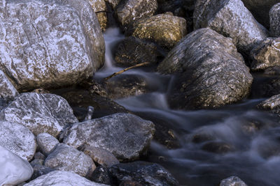 Close-up of pebbles in water