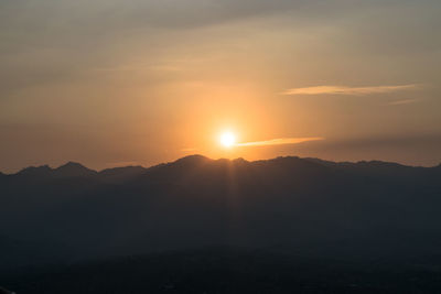 Scenic view of silhouette mountains against sky during sunset