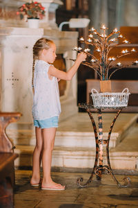 Full length of cute girl standing on table