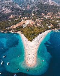 View over bol, croatia with drone capturing turquoise adriatic sea and beach life during the summer.