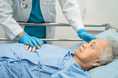 Doctor checking senior  woman patient lie down in nursing hospital  