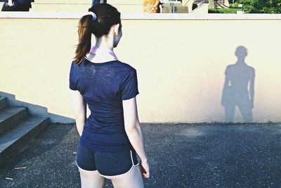 Rear view of woman standing in park