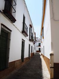 Narrow alley amidst buildings against sky