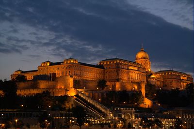 Illuminated city against sky at night