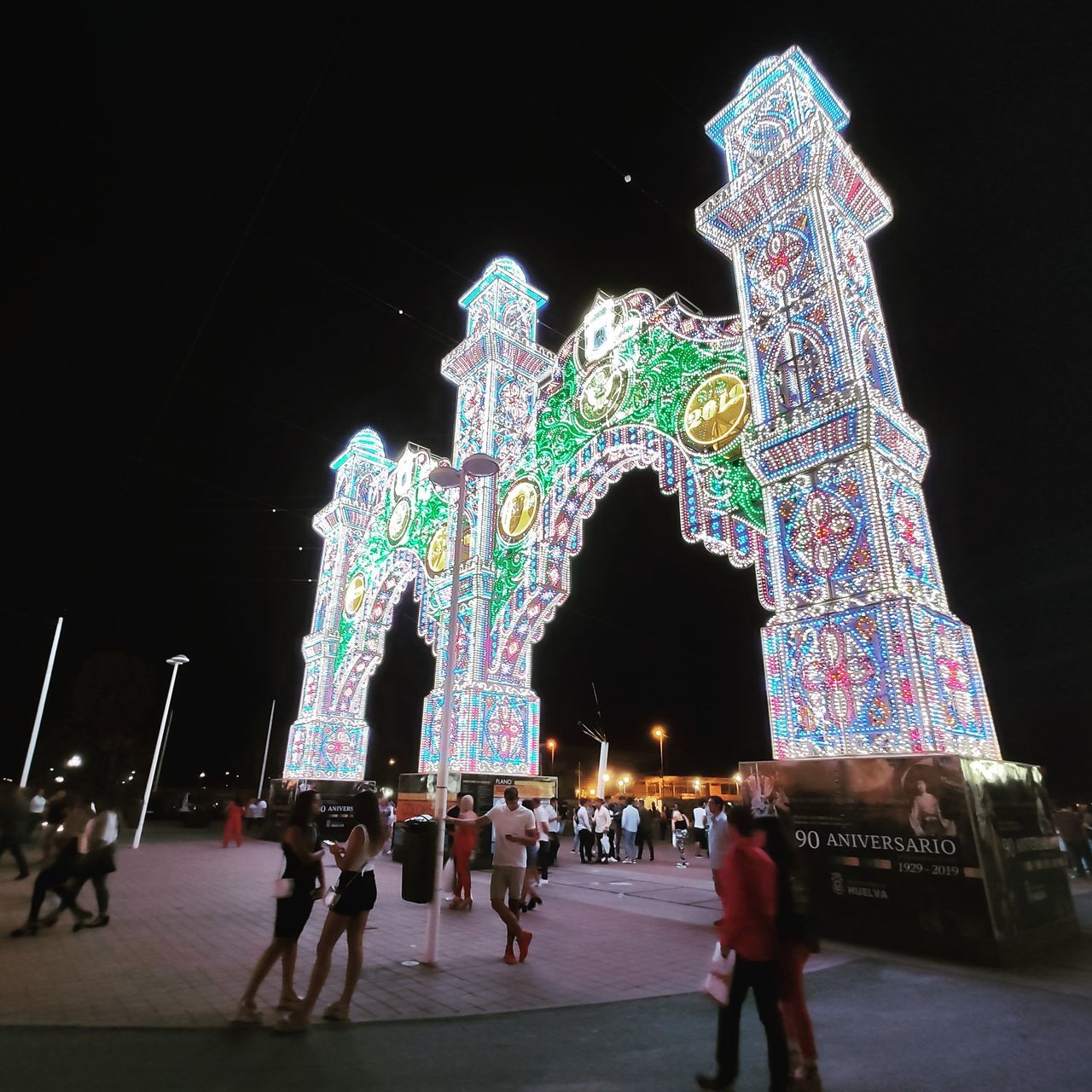 PEOPLE ON ILLUMINATED BUILDING AT NIGHT