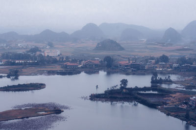 High angle view of river amidst buildings against sky