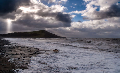 Scenic view of sea against cloudy sky