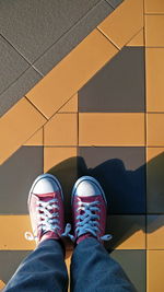 Low section of person standing on footpath