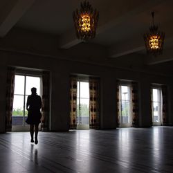 Full length of woman in illuminated room