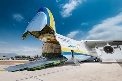 Low angle view of airplane on airport runway against sky